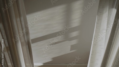 Window shadow moving on wall with curtains