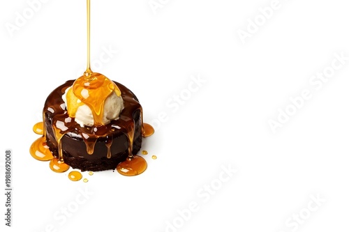 Chocolate brownie cake topped with vanilla ice cream and pouring caramel