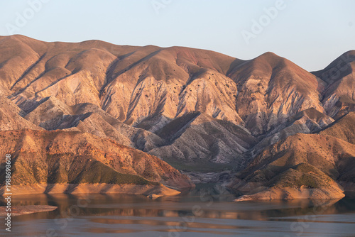 A majestic reservoir with calm blue waters set in an arid, rugged landscape, illustrating recreation along the Azat River in Armenia and the concept of soil irrigation