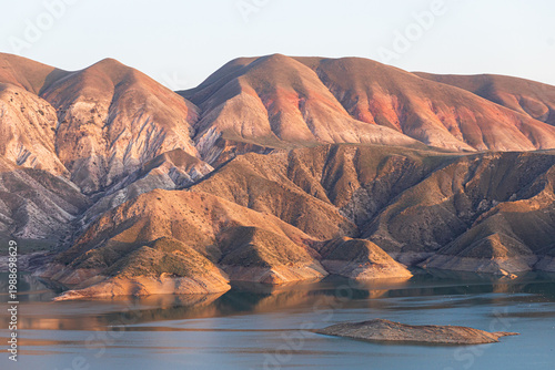 A majestic reservoir with calm blue waters set in an arid, rugged landscape, illustrating recreation along the Azat River in Armenia and the concept of soil irrigation