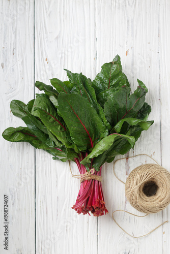 Fresh organic chard on a wooden background, Sweet beet leafs (mangold) . Selective focus