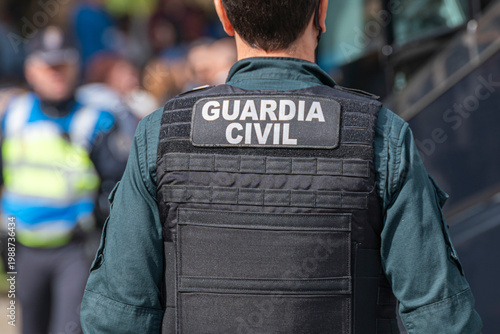 Guardia Civil officer back view with tactical vest The Concept of safety and law