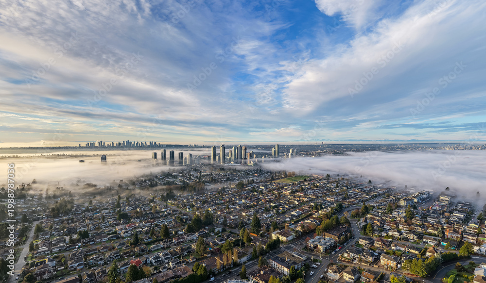 Fototapeta premium Aerial Morning Fog Over Burnaby Skyline and Suburban Neighbourhoods in Greater Vancouver, BC