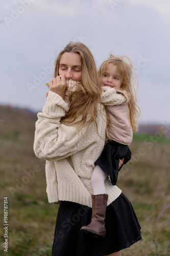 Cozy moments of mother and daughter outdoors