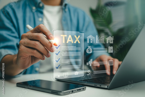 Person filling digital tax form with electronic pen on tablet and laptop for comprehensive financial reporting and compliance.