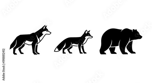 Silhouettes of a wolf, fox, and bear standing side by side
