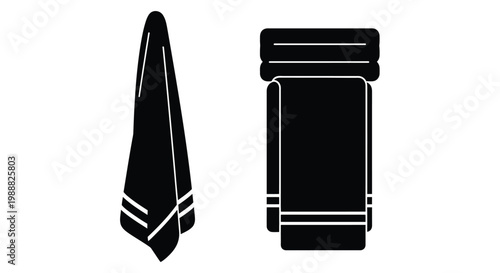Folded towel and stacked container depicted in a dark silhouette