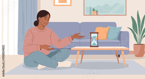 Woman sitting on floor looking at hourglass on coffee table, time passing concept