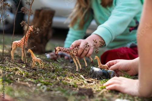 Children Playing With Toy Animals Outdoors