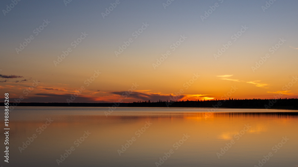 Obraz premium Sunset reflections on Riding Mountain National Park's Clear Lake,
