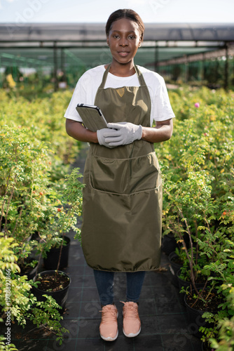 Black farmer with tablet on farm
