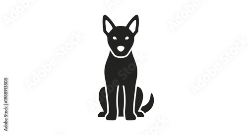 Black dog sitting on ground calmly.