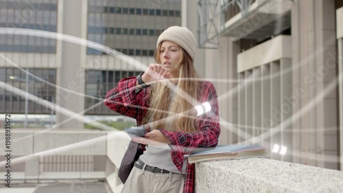 Student checking phone, tapping watch for edu schedule causing light streaks and sorting papers