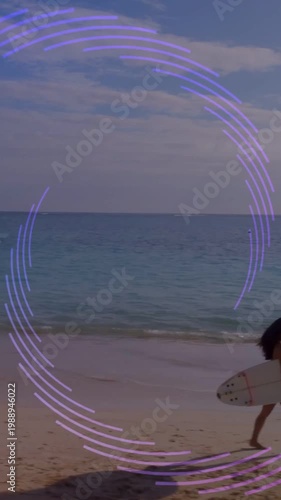 Vertical video: Appearing purple arc, surfer in bikini walking beach to surf with board, copy space