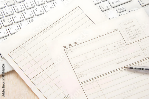 Japanese Resume Form with Pen and Keyboard on Desk