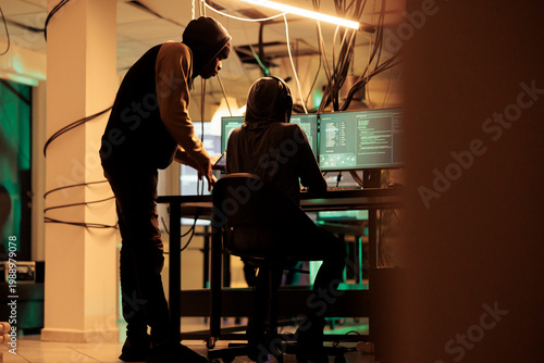 Slika na platnu Online criminals analyzing script codes to hack government system, attacking sensitive sever and causing security breach