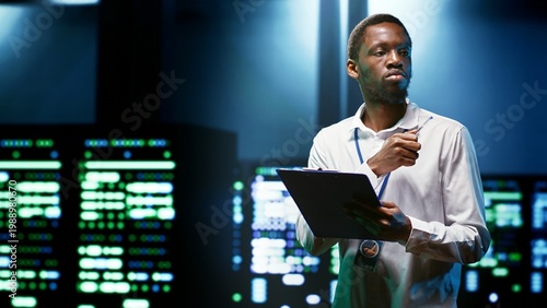 African american engineer preventing supercomputer cybersecurity issues arising due to unsecured network connections. Specialist making sure data center is invulnerable to phishing attacks