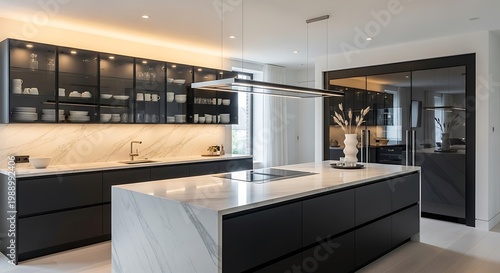 A stunning contemporary kitchen featuring a spacious marble island, sleek black cabinetry, and integrated modern appliances.