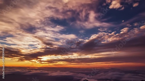 Dramatic sunset sky over vast snowy mountains