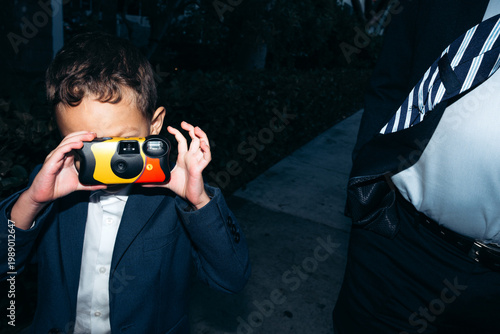 Kid using disposable camera
