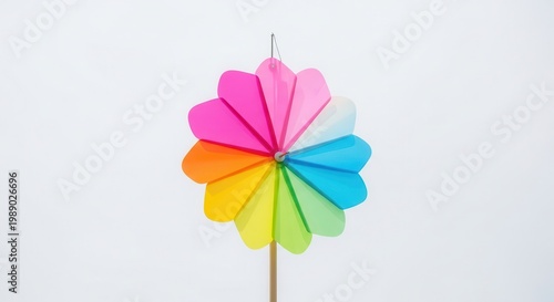 Vibrant multicolored pinwheel against a pure white background, showcasing a spectrum of cheerful