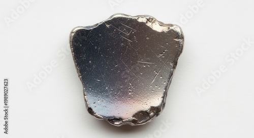 Close-up of a shimmering raw metallic fragment showcasing industrial material texture on a clean