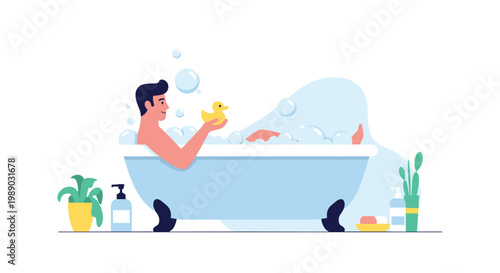 Young man relaxing and having fun in a bubble bath while holding a yellow rubber duck in a clean white bathroom.