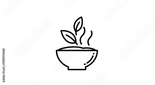 A steaming bowl with green leaves.