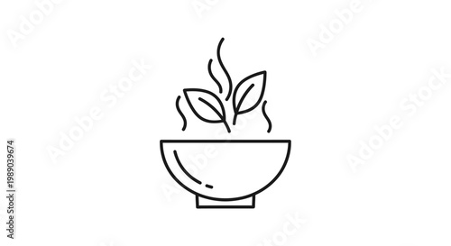 A bowl with steam and leaves.