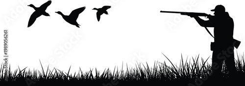 Silhouette hunter aims shotgun at flying ducks over grass