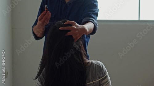 Victim of human trafficking tied with rope while criminal admister anesthetic