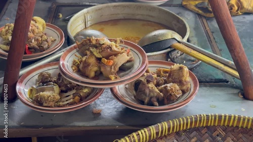 Tengkleng cooking, Sate Buntel Close-up of cooking process using traditional stove. Spicy Tengkleng or Tongseng - Indonesian food, Sate Buntel Solo
