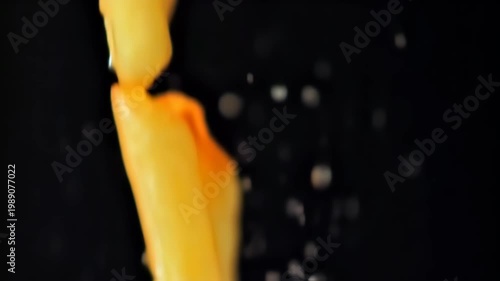 dropped potato on black background