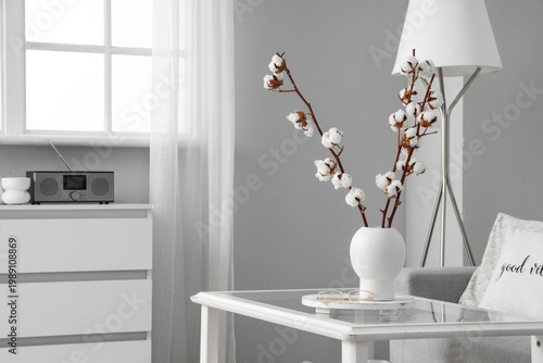Vase with cotton flowers an...