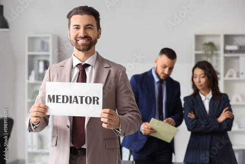 Young man holding paper wit...