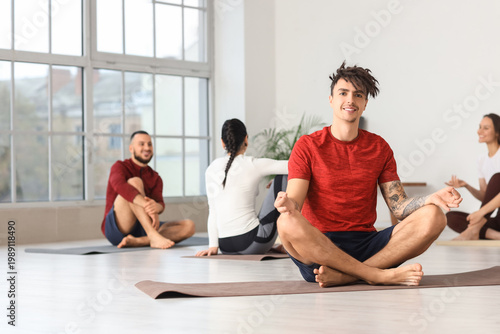 Sporty young man meditating...