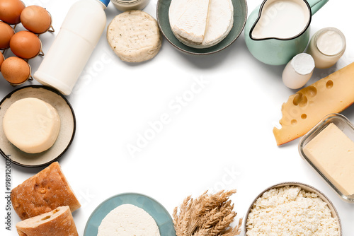Fotografie Frame made of different dairy products with bread, eggs and wheat spikelets on w