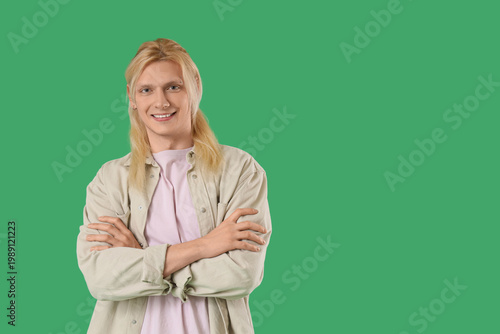 Young blonde man smiling on...