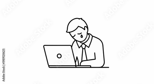 Man crying while working on laptop