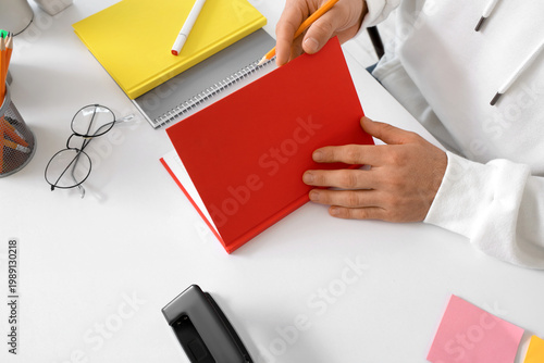 Young man with stationery a...