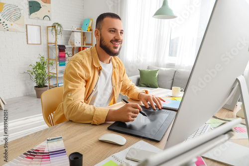 Male interior designer working with tablet in office