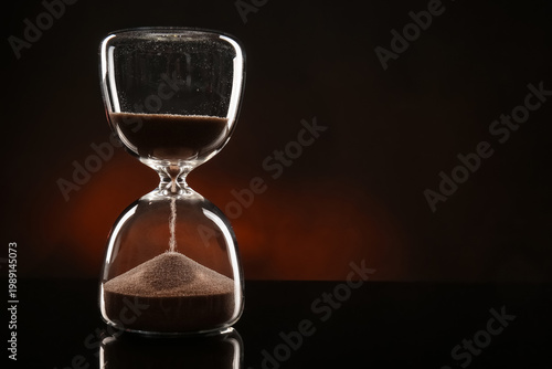 Crystal hourglass on dark b...