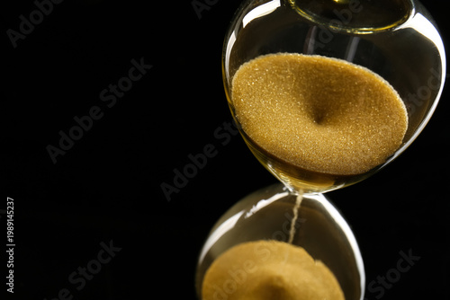 Crystal hourglass on black ...