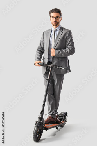 Handsome businessman riding...