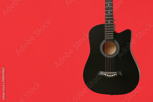 Modern black guitar on red ...