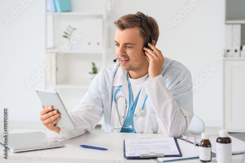 Male doctor in headset with...