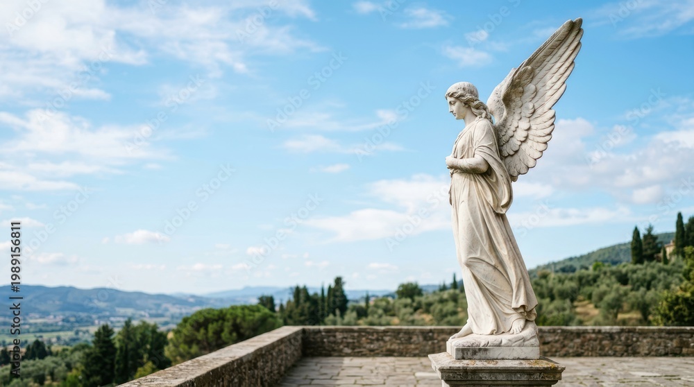 Obraz premium Serene angel statue overlooking a rolling Tuscan landscape under a blue sky