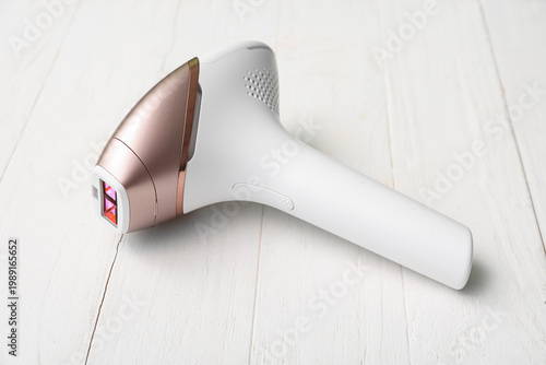 Modern photoepilator on whi...