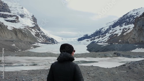 Woman hiking Athabasca Glacier enjoying frozen landscape in Jasper National Park