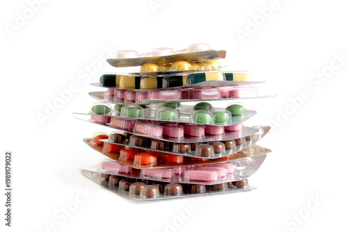 Bild auf Leinwand On a white background lies a pile of blisters with medicine tablets